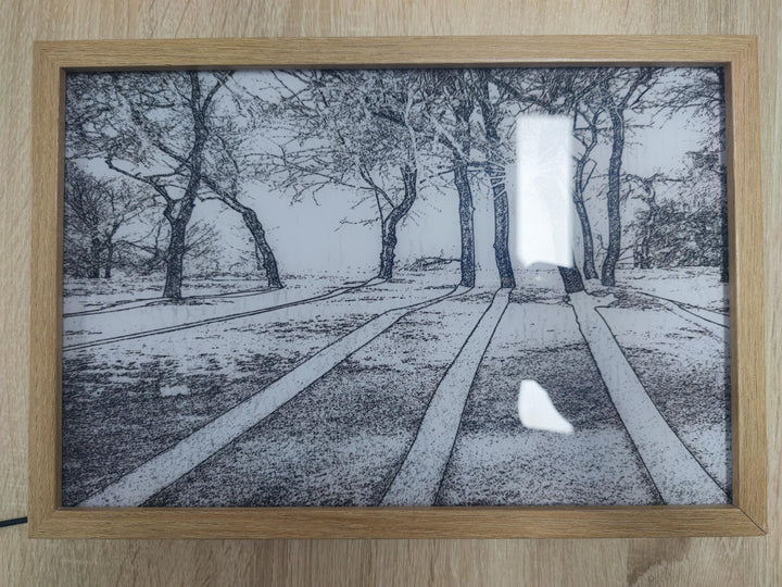 Verlicht schilderij met zonlicht door een raam
