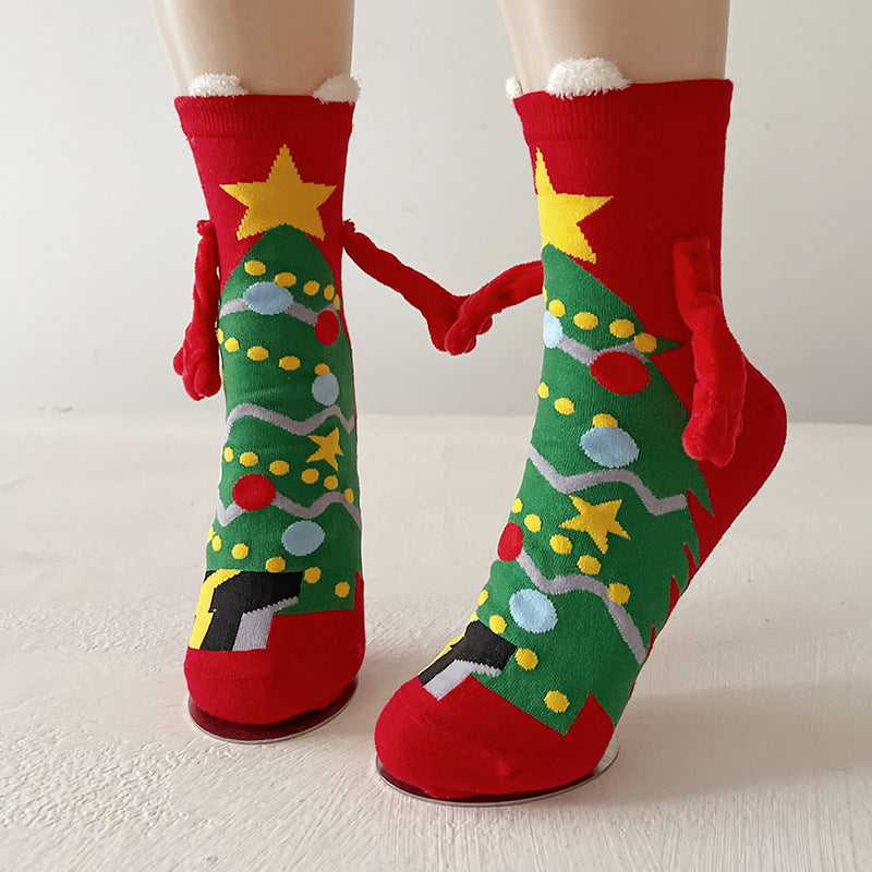 Twee kerstsokken met magnetische handjes