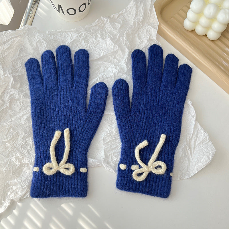 Geribde handschoenen met strikje bij de pols