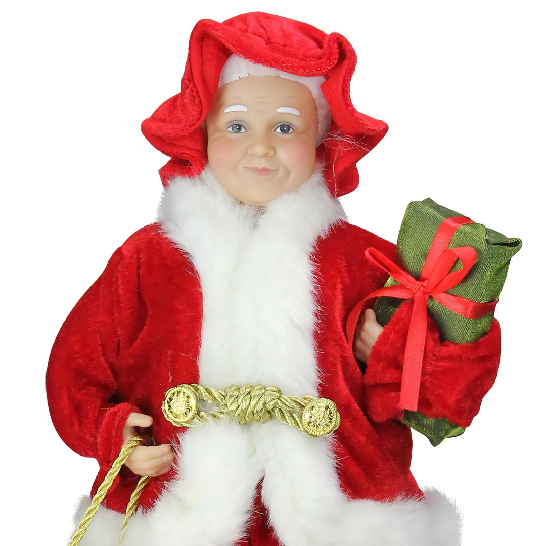 Kerstvrouw-beeldje in rode jurk met cadeau