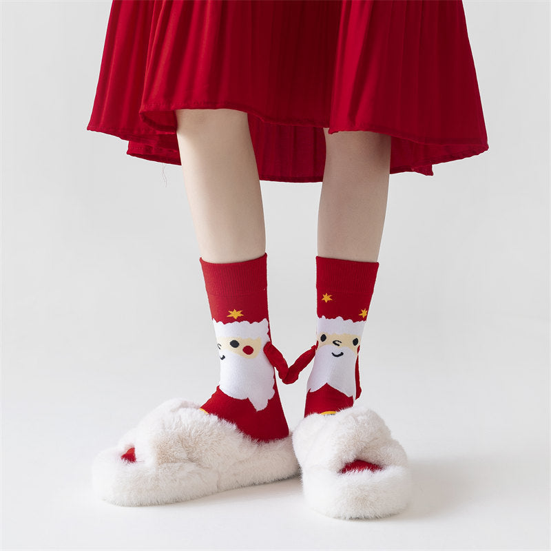 Twee kerstsokken met magnetische handjes