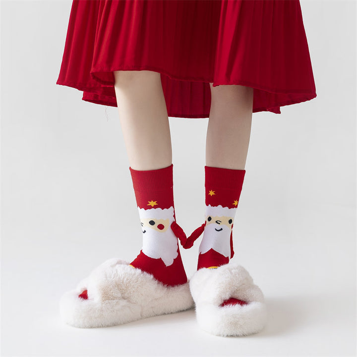 Twee kerstsokken met magnetische handjes