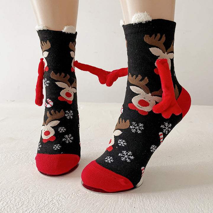Twee kerstsokken met magnetische handjes