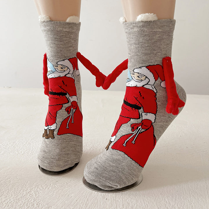 Twee kerstsokken met magnetische handjes