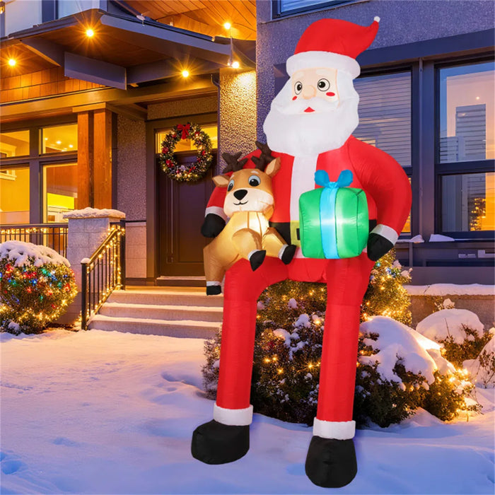 Warmteparadijs Opblaasbare zittende kerstman met rendier en cadeau, 290 cm