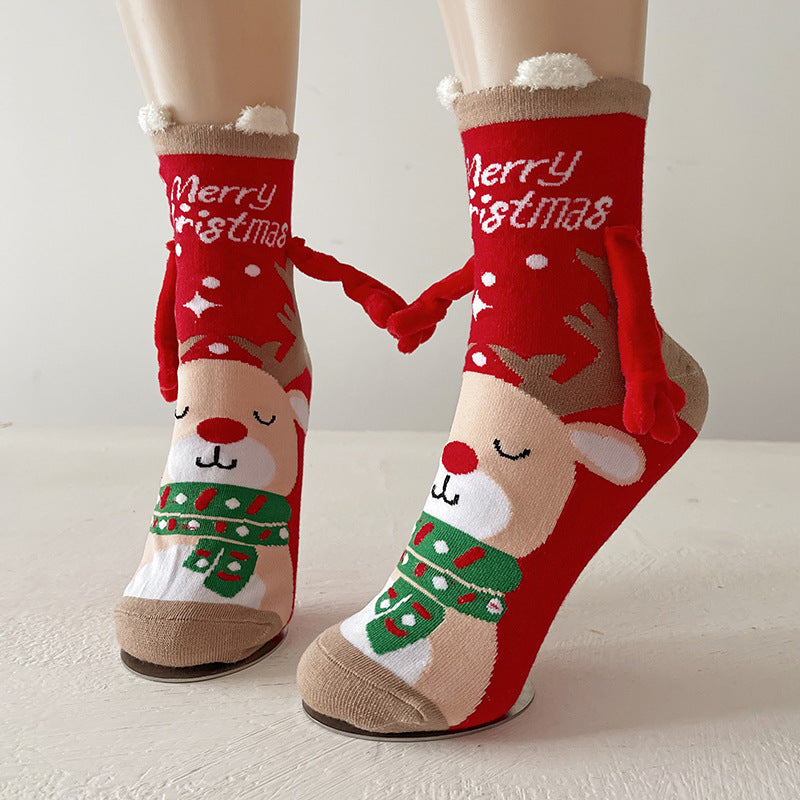 Twee kerstsokken met magnetische handjes