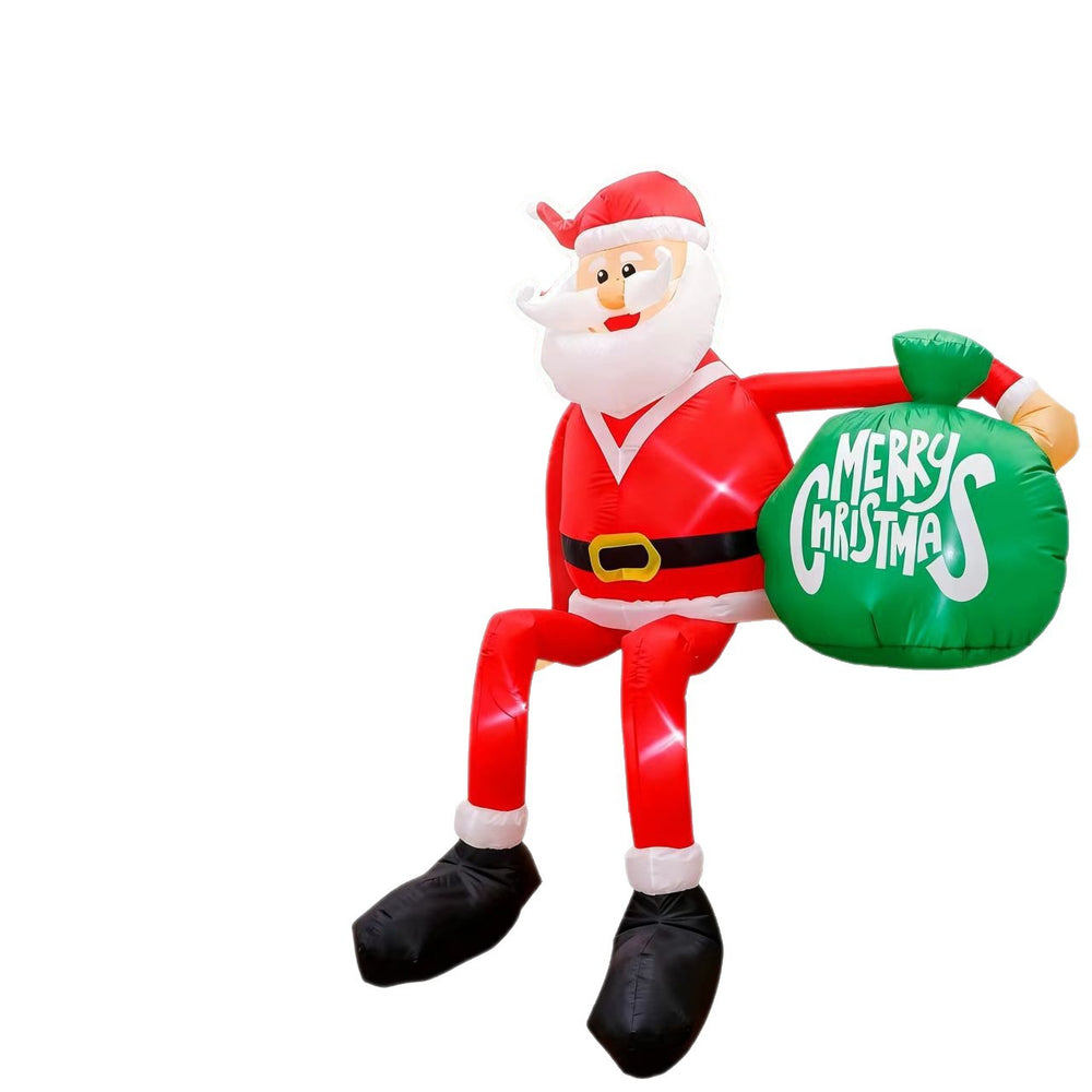 Opblaasbare kerstman met cadeauzak in tuin