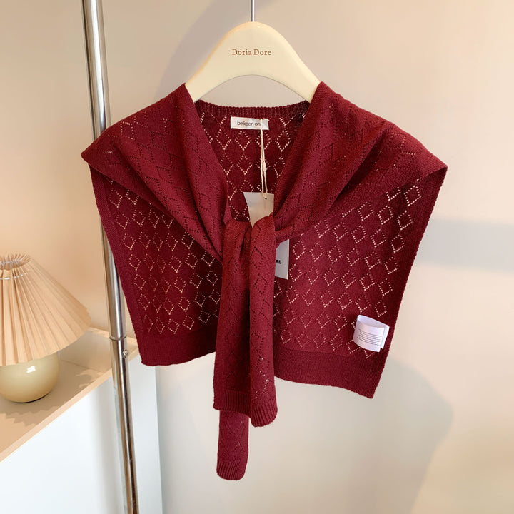Vrouw met gebreide schouderdoek gestrikt